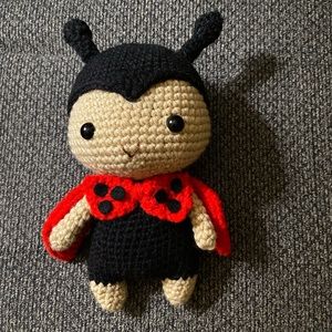 Crocheted amigurumi doll black and red